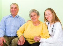caregiver with elderly patients smiling